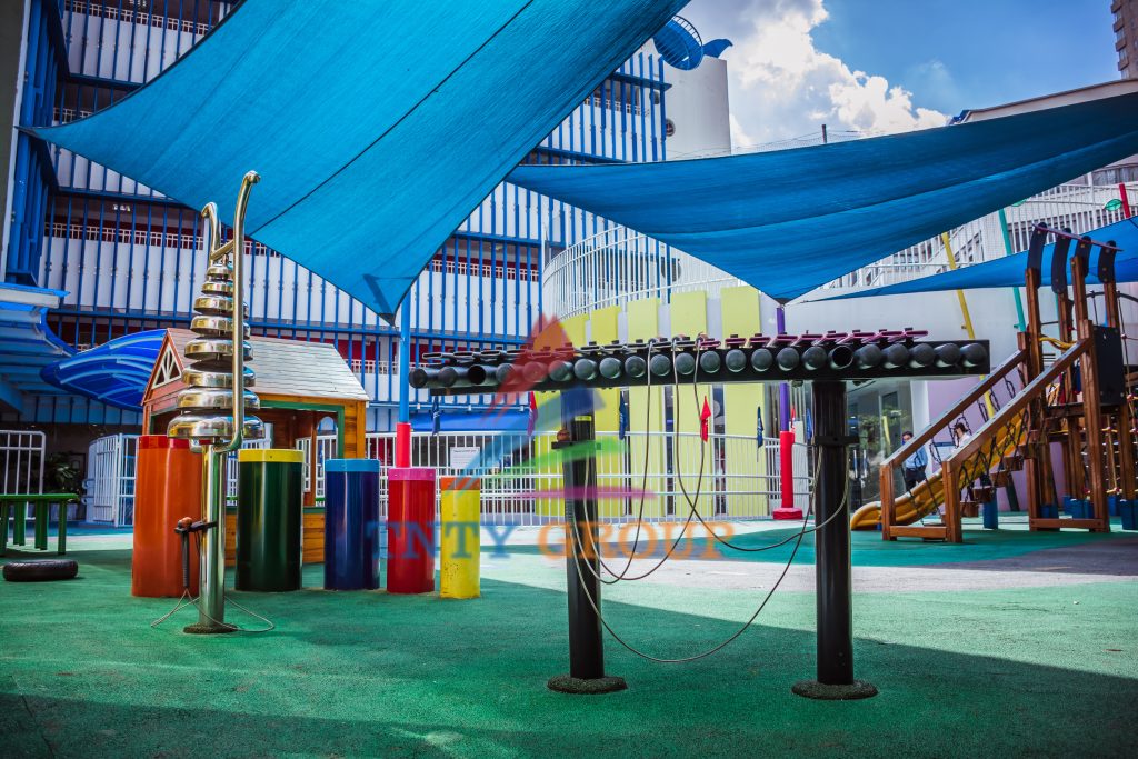 School playground with play equipment and safety surfacing at International School Saigon Pearl