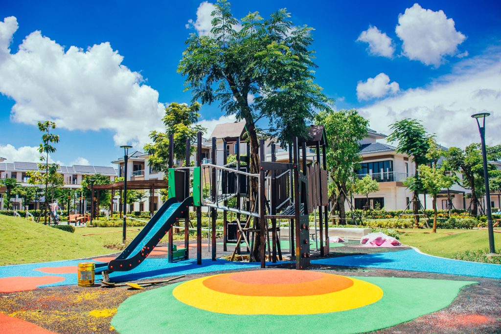 Children playing on play equipment over rubber surfacing at Dai Phuoc Lotus Zone 4