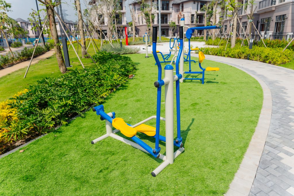 Outdoor playground with climbing frame and rubber safety surfacing at GS Metro City