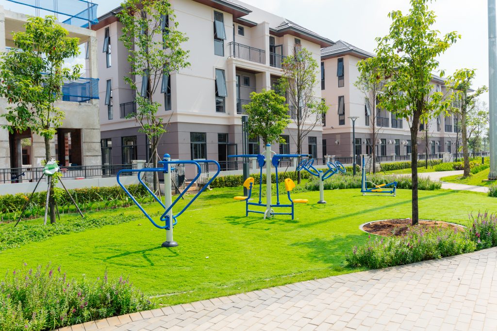 Seamless wet-pour EPDM rubber surfacing laid around playground equipment at GS Metro City